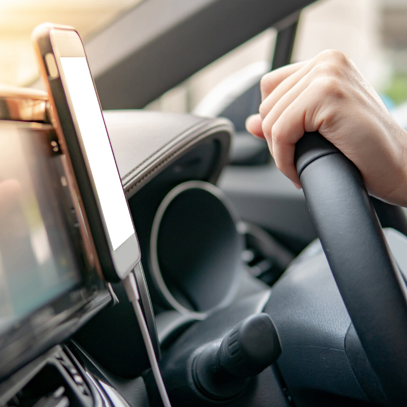 Driving in city traffic and playing with a mobile phone in cradle